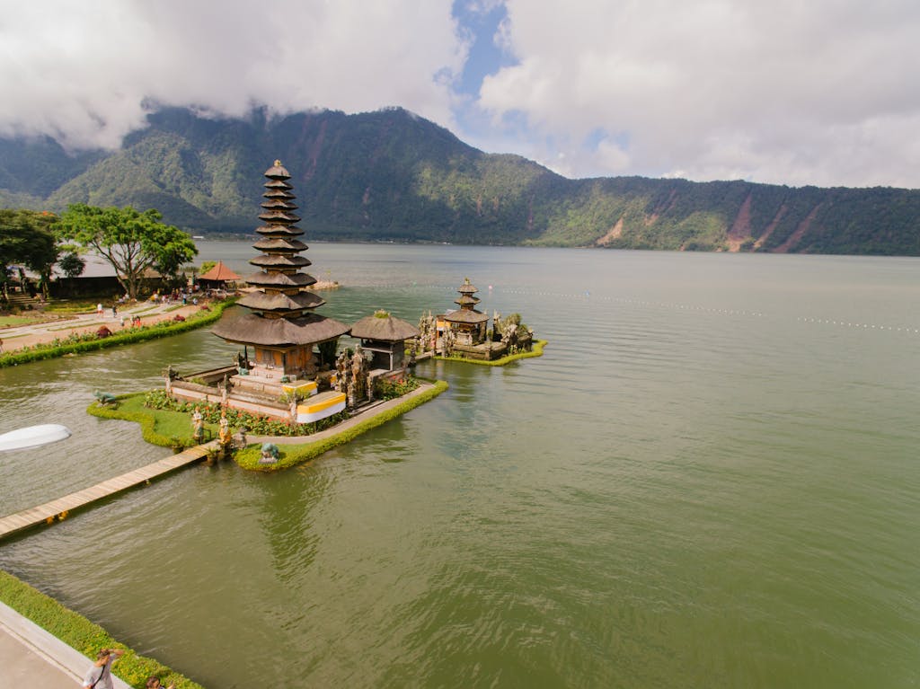 HOME A stunning aerial view of Pura Ulun Danu Bratan Temple situated by a serene lake in the highlands of Bali, Indonesia.