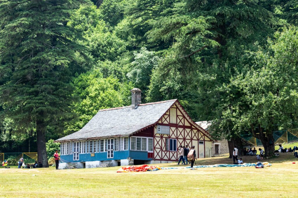 Himachal Tour Packages Charming cottage amidst lush greenery in Khajjiar, Himachal Pradesh, India.